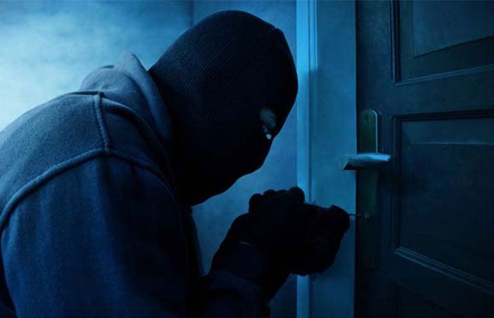 Burglar picking a home door lock