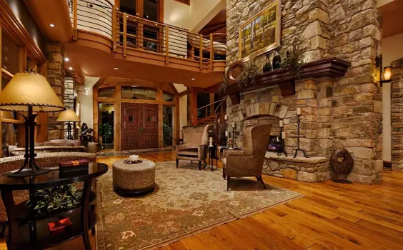 Beautifully lit large traditional entryway with exposed stone fireplace