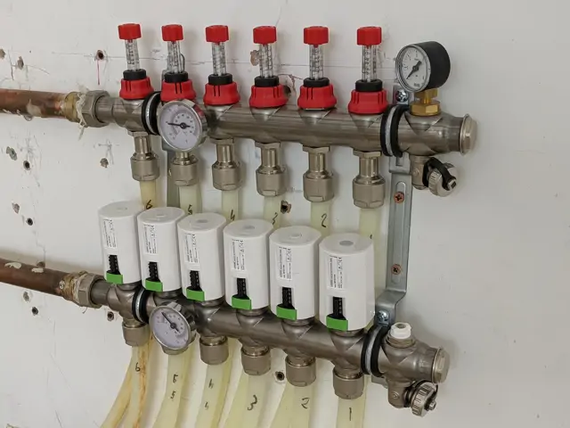 Loxone smart heating valve actuators fitted to multi-zone underfloor heating